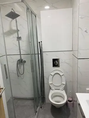 a bathroom with a toilet and a glass shower at Nata 25 in Becici