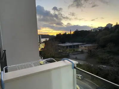 a view of a sunset from the balcony of a building at Nata 25 in Becici