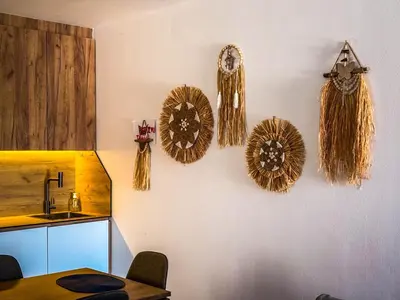 a kitchen with a wall with some decorations on it at TaNa's Villa in Donji Štoj