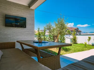 a patio with a table and chairs and a window at TaNa's Villa in Donji Štoj