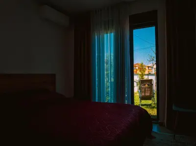 a bedroom with a bed and a window with a view at TaNa's Villa in Donji Štoj