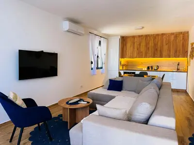 a living room with a couch and a tv at TaNa's Villa in Donji Štoj