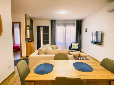 a living room with a table and a couch at TaNa's Villa in Donji Štoj