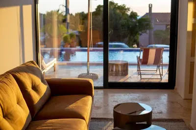 a living room with a couch and a view of a pool at Casa del Sol Zagora in Zagora