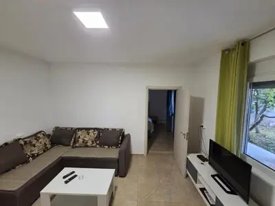 a living room with a couch and a tv at Guest house Danica in Bar