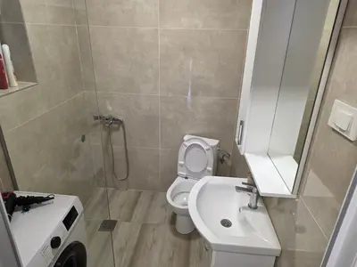 a bathroom with a toilet and a sink and a shower at Guest house Danica in Bar