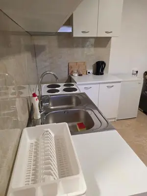 a kitchen with a sink and a stove at Guest house Danica in Bar