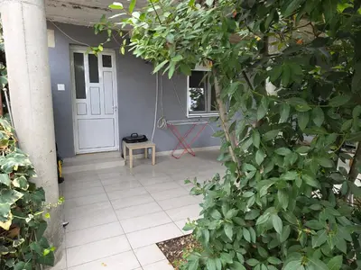 a porch with a door and a bench next to a plant at Guest house Danica in Bar