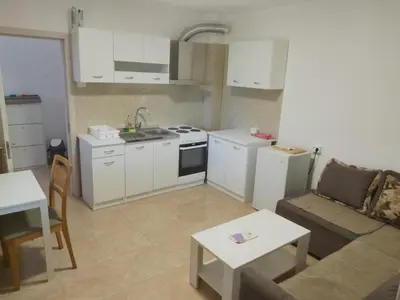a kitchen and living room with a couch and a table at Guest house Danica in Bar