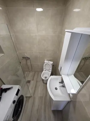 a bathroom with a white toilet and a sink at Guest house Danica in Bar