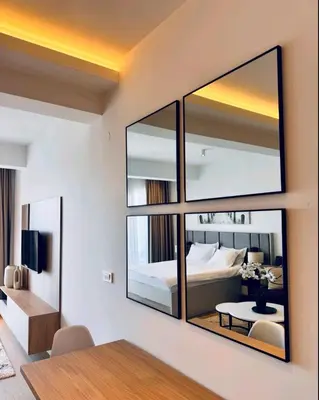 a bedroom with a large mirror on the wall at Apartman Gioia in Becici