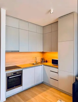 a kitchen with white cabinets and a sink at Apartman Gioia in Becici