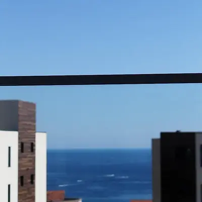 a view of the ocean from a window of a building at Apartman Gioia in Becici