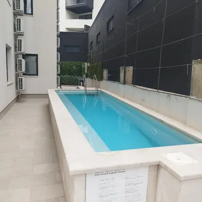 a swimming pool on the roof of a building at Apartman Gioia in Becici