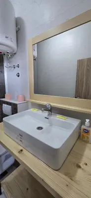 a bathroom with a white sink and a mirror at Beachfront Blue Panorama in Bar