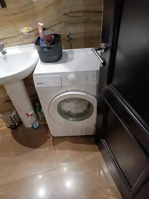a bathroom with a washing machine and a sink at Martina Apartmani in Budva