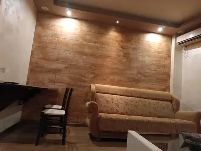 a living room with a couch in front of a wall at Martina Apartmani in Budva