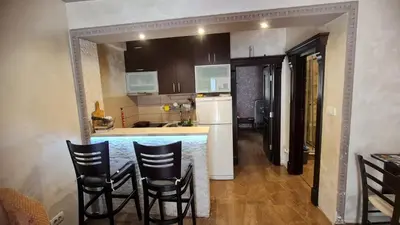 a kitchen with a bar and some chairs in it at Martina Apartmani in Budva