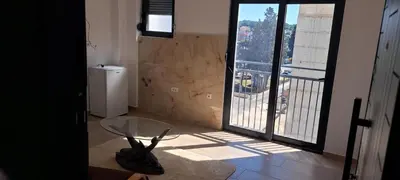 a room with a glass table and a large window at Apartments Arb in Ulcinj