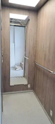 a bathroom with a mirror and a door in a room at Apartments Arb in Ulcinj