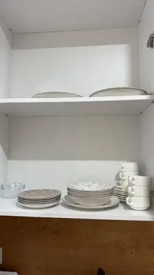 a shelf with plates and dishes on it in a kitchen at Soho holiday in Bar