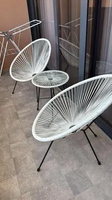 two white benches and a table in a room at Soho holiday in Bar