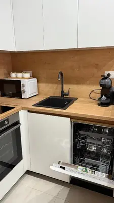 a kitchen with a sink and a microwave at Soho holiday in Bar