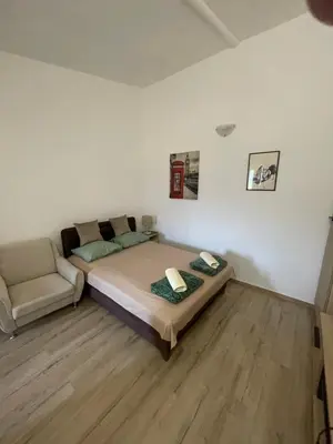 a bedroom with a bed and a couch in it at Maric in Tuzi