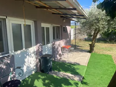 a patio with a table and chairs on a house at Maric in Tuzi