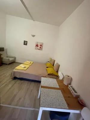a small bedroom with a bed and a table at Maric in Tuzi
