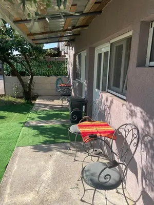 a patio with a table and chairs on a house at Maric in Tuzi