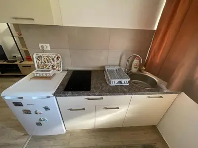 a small kitchen with a sink and a counter top at Maric in Tuzi