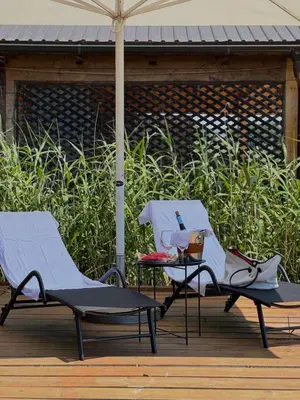 two lounge chairs and an umbrella on a deck at Casa Tiramisù in Ulcinj