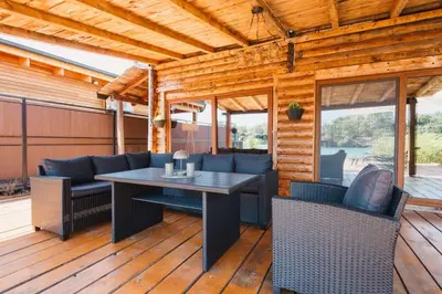 a patio with a table and chairs on a deck at Casa Tiramisù in Ulcinj