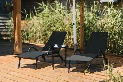 two chairs and a table on a wooden deck at Casa Tiramisù in Ulcinj