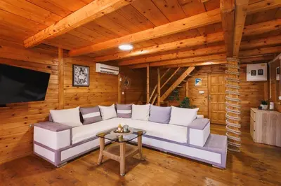 a living room with a white couch and a tv at Casa Tiramisù in Ulcinj