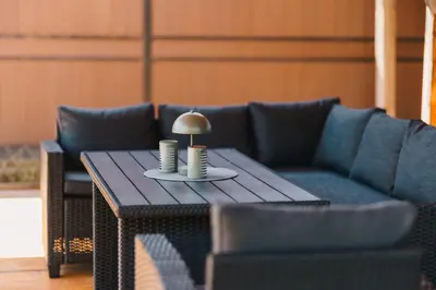 a living room with a couch and a table with a lamp at Casa Tiramisù in Ulcinj