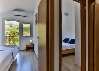 a small bedroom with a bed and a window at Palm Park Budva in Budva