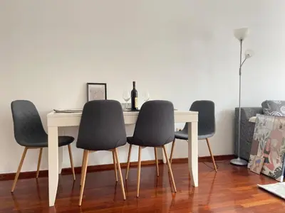 a dining room table with four chairs around it at Cozy city apartment Podgorica in Podgorica