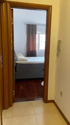 a view of a bedroom with a bed through a door at Cozy city apartment Podgorica in Podgorica