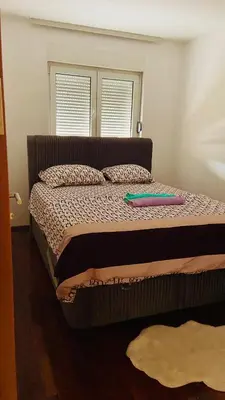 a bed with a frisbee sitting on top of it at Cozy city apartment Podgorica in Podgorica