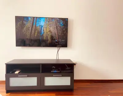 a flat screen tv sitting on a wall at Cozy city apartment Podgorica in Podgorica