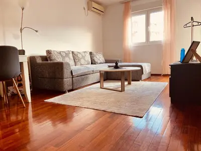 a living room with a couch and a coffee table at Cozy city apartment Podgorica in Podgorica