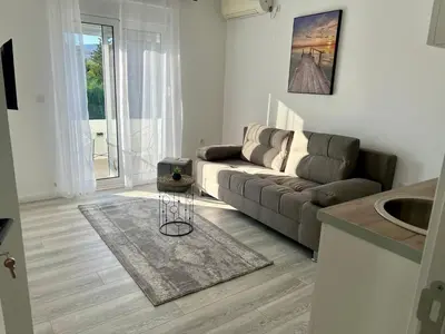 a living room with a couch and a table at Harasani apartments in Ulcinj