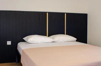 a bed with two white pillows in a bedroom at Harasani apartments in Ulcinj