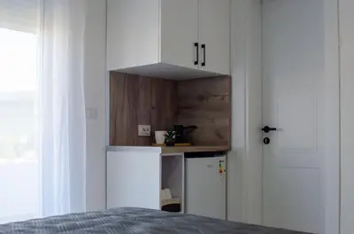 a kitchen with a refrigerator and a white cabinet at Harasani apartments in Ulcinj