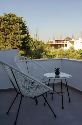 a white chair and a table on a balcony at Harasani apartments in Ulcinj