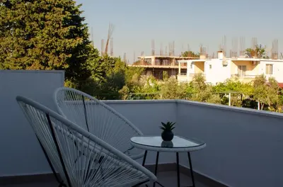 a small table and two chairs on a balcony at Harasani apartments in Ulcinj