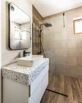 a bathroom with a sink and a mirror at Skyline Residences in Bigovo
