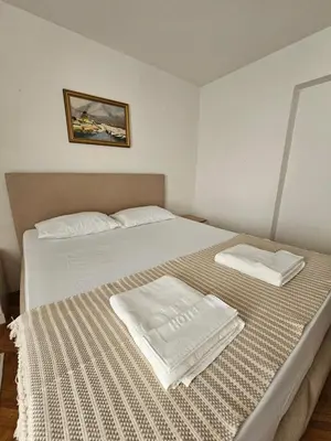 a bedroom with a bed with two towels on it at Lena's Place Near City Center in Bar